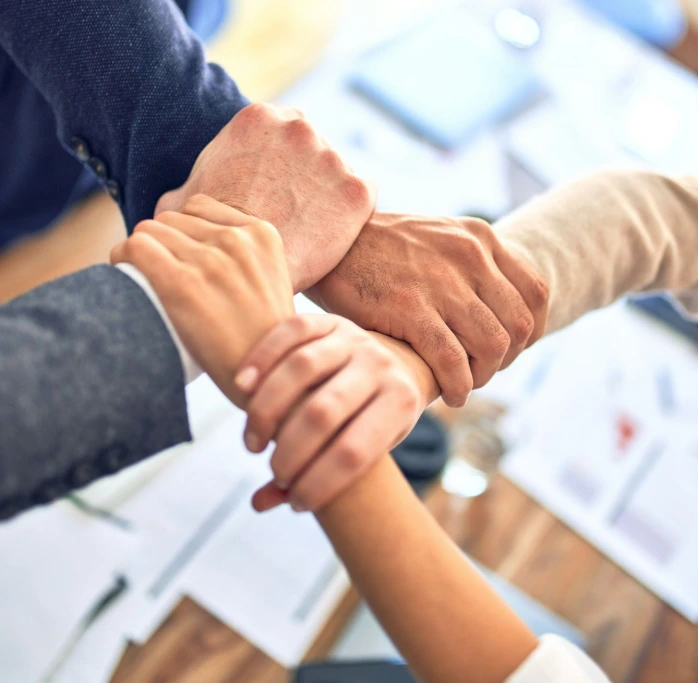 team members gripping wrists in unity gesture